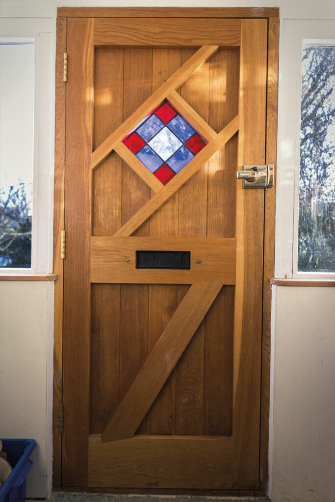 Wooden door with stained glazing